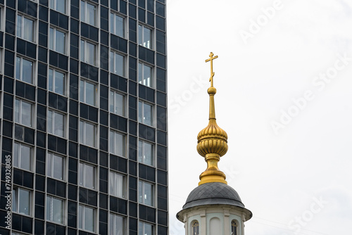 A characteristic architectural solution to harmonize the building of a modern style and the traditional style of the church. The concept of the relationship between old and new.