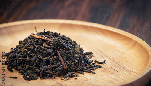 close-up of dry Chinese tea in wooden bowl, vintage tone, selective focus