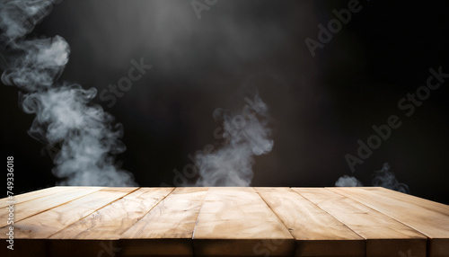 empty wooden table with smoke float up on dark background for your design and concept