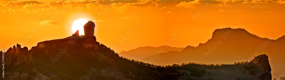 Landscape, sunset and panoramic view of mountains, Gran Canaria Island with nature skyline and environment. Orange sky, horizon and natural background with travel location or destination in Spain