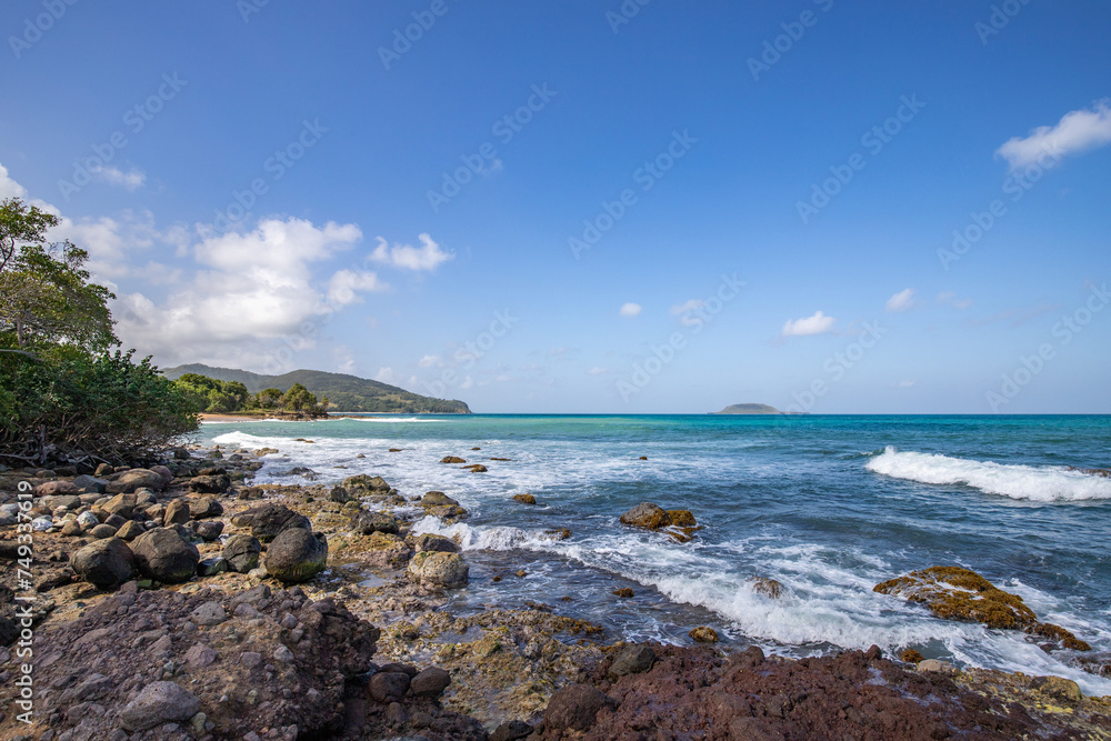 Nature in a special landscape. A rocky coast by the sea. Great landscape shot of cliffs in the Caribbean, the waves breaking against the island of Guadeloupe in the French Antilles. Nature in a special landscape. A rocky coast by the sea. Great landscape shot of cliffs in the Caribbean, the waves breaking against the island of Guadeloupe in the French Antilles.