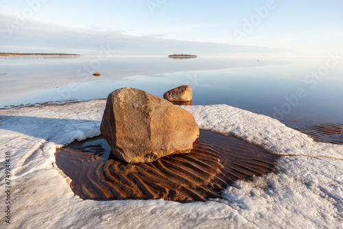 Fototapeta Naklejka Na Ścianę i Meble -  Tranquil spring evening by the calm sea on a sandy beach with still some ice left, Bothnian Bay, Baltic Sea, Finland