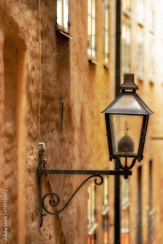 Travel, architecture and lamp on vintage building in old town with history, culture or holiday destination in Sweden. Vacation, landmark and antique lantern in Stockholm with retro light ancient city