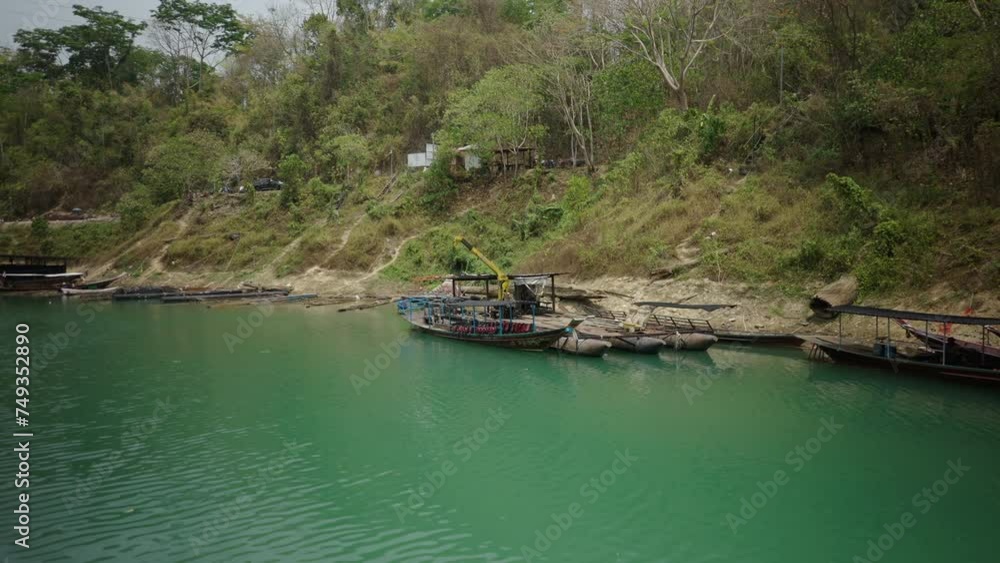 Few small boats are lying in the water Few small boats are lying in the water