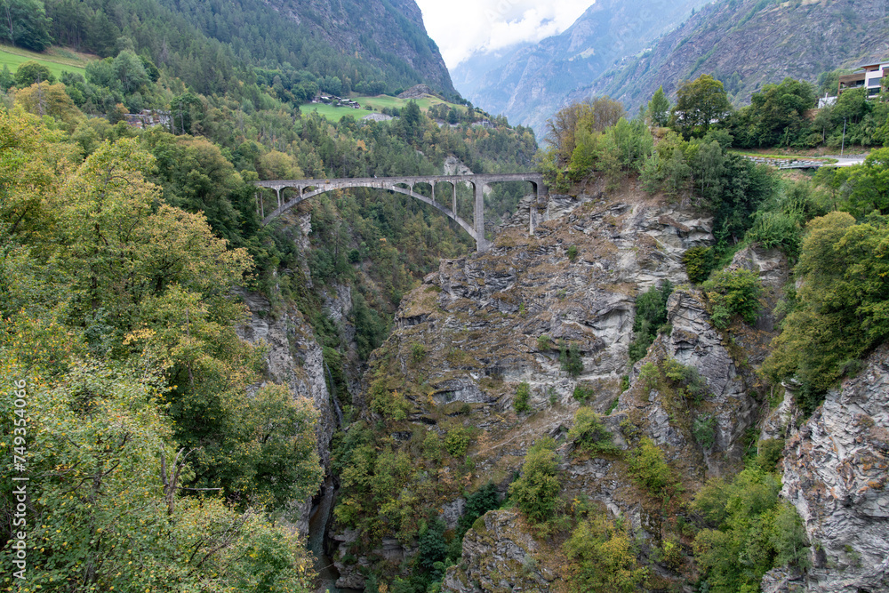 Panoramic view over the Stalden, Switzerland landscape with the 1930, 108 meters long Visp or Stalden bridge from bridge designer, A. Sarrasin crossing a gorge in the Valais region
