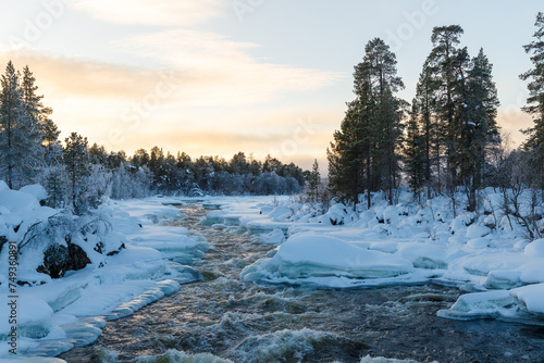 Fototapeta Naklejka Na Ścianę i Meble -  River in Finnish Lapland between ice and snow
