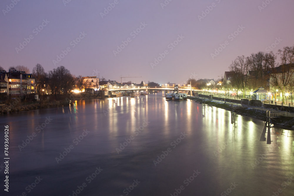 A serene river flowing through city in night
