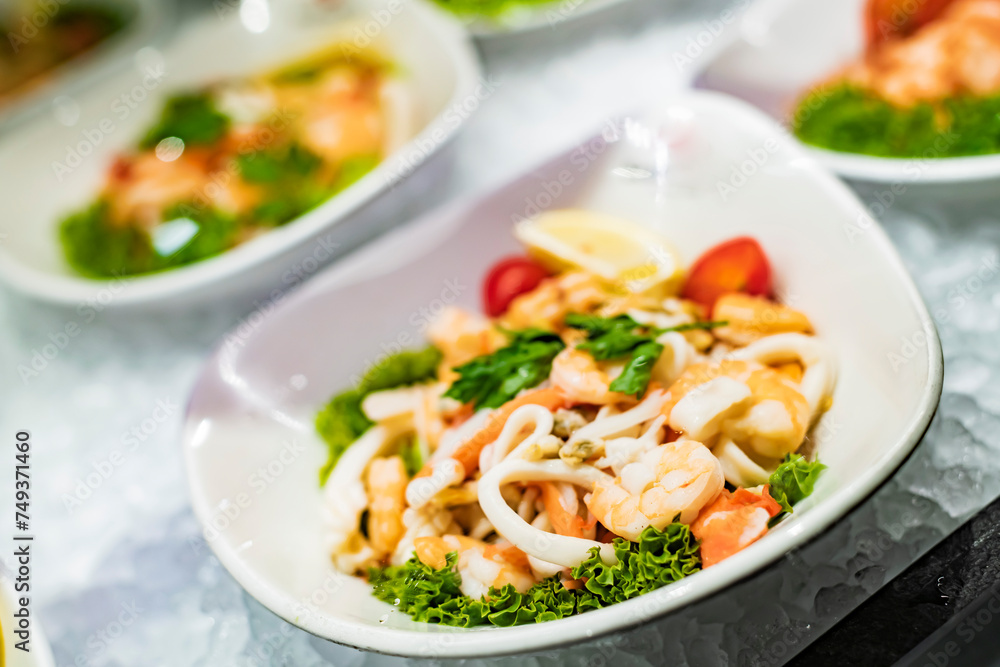 Seafood salad plates displayed in a restaurant refrigerator Seafood salad plates displayed in a restaurant refrigerator