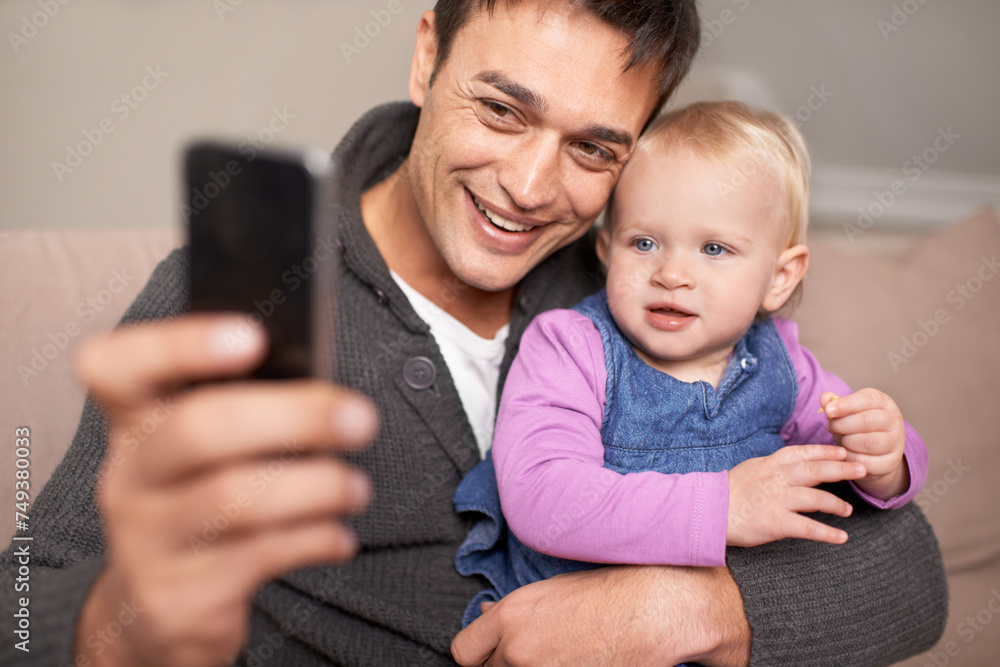 Happy family, father and baby with selfie in home, love and care of new parent in living room. Dad, daughter and smile with cellphone for profile picture, cute and bonding together on sofa in house Happy family, father and baby with selfie in home, love and care of new parent in living room. Dad, daughter and smile with cellphone for profile picture, cute and bonding together on sofa in house