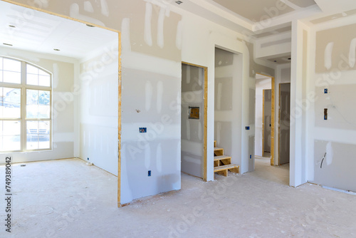 Plastering drywalling newly constructed house during construction phase photo