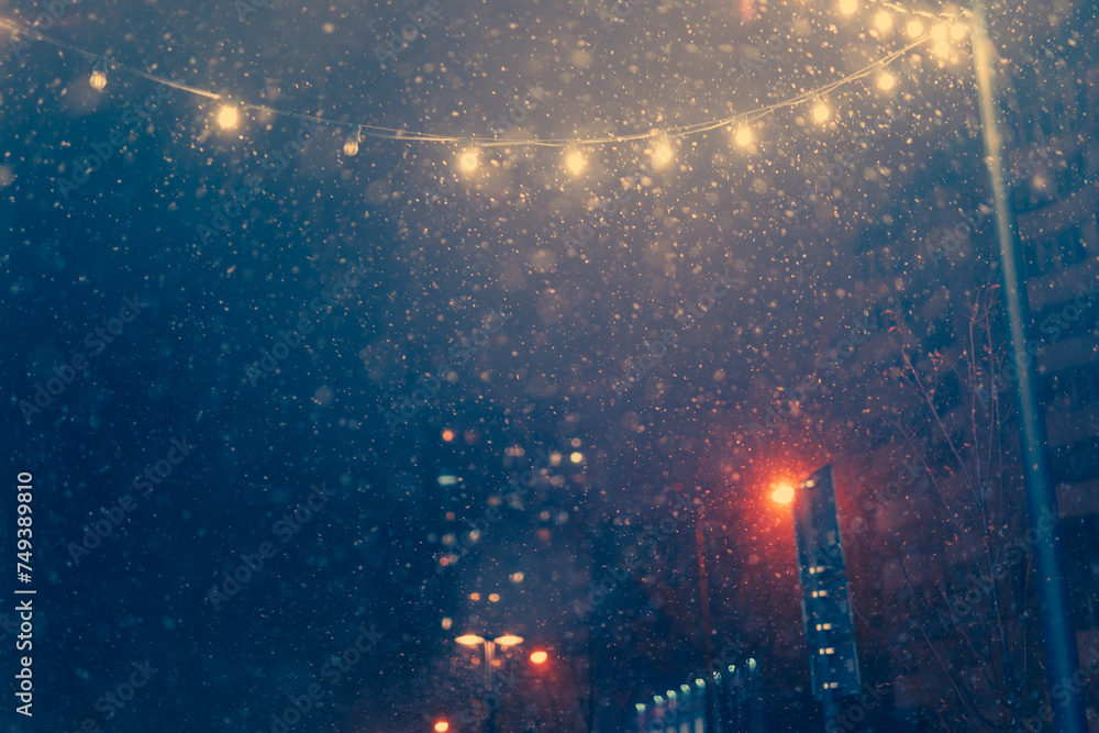The texture of the snow. Winter in the night city. Snowflakes and street lights