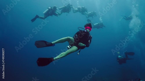 A group of divers at a depth of several metres photo