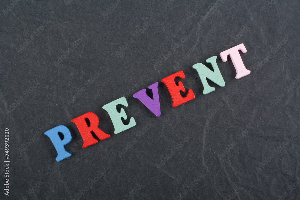 PREVENT word on black board background composed from colorful abc alphabet block wooden letters, copy space for ad text. Learning english concept. PREVENT word on black board background composed from colorful abc alphabet block wooden letters, copy space for ad text. Learning english concept.
