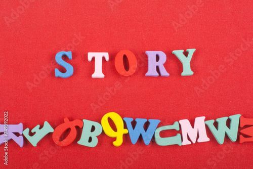 STORY word on red background composed from colorful abc alphabet block wooden letters, copy space for ad text. Learning english concept.