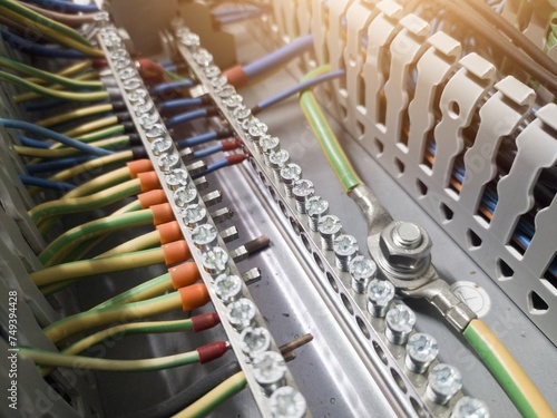 Fotografie Terminals connection wiring cables grounding and neutral point  by tightening the bolts on the panel control