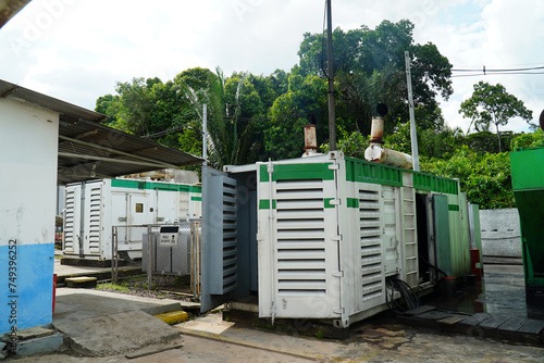 Diesel generator that produces black clouds of smoke to produce electricity for the population in small towns and distant villages in the Amazon rainforest. Itacoatiara, Amazonas state, Brazil.