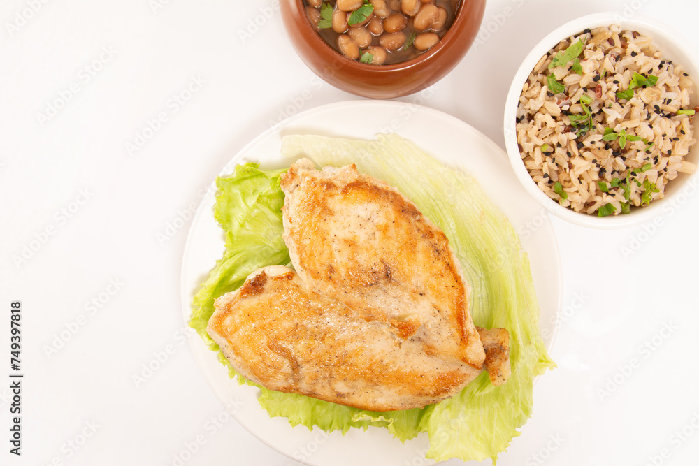 Grilled chicken in a plate with salad and rice isolated clean white background top view photo Grilled chicken in a plate with salad and rice isolated clean white background top view photo