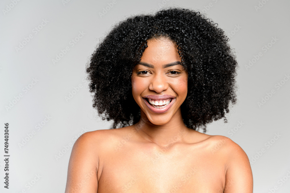 An exuberant African-American woman with a beaming smile and sparkling eyes fills the frame with pure joy, set against a light grey background, showcasing a candid and infectious happiness An exuberant African-American woman with a beaming smile and sparkling eyes fills the frame with pure joy, set against a light grey background, showcasing a candid and infectious happiness
