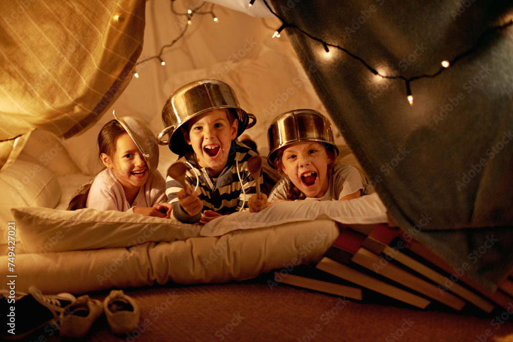 Tent, lights and portrait of children at night in bedroom for playing, fun and bonding at home. Friends, youth and happy kids with spoon, helmet pots and blanket fort for games, relax and childhood