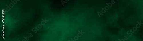 Abstract background with green paper texture and green watercolor painting background. smoke fog or clouds in center with dark border grunge design. black and green grunge watercolor background.