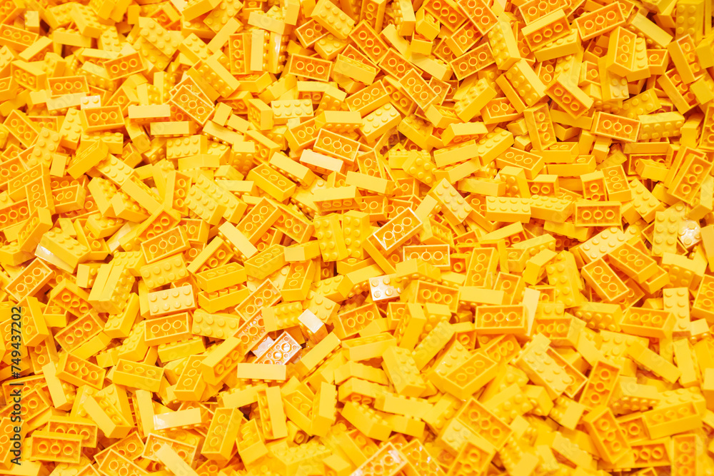 Naklejka premium Billund, Denmark - 17 June 2023: Yellow plastic Lego brick background
