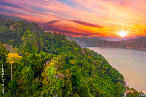 Aerial view mountains cliff rain forest jungle Phi phi island lagoon bay with a unique nature environment, during sunrise red orange sky