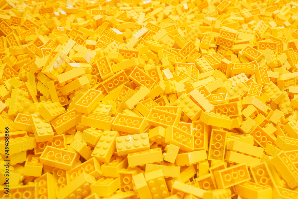 Obraz premium Billund, Denmark - 17 June 2023: Yellow plastic Lego brick background