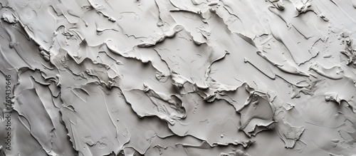 A detailed close-up view of a concrete wall covered in smooth white paint. The texture of the wall is visible, adding depth to the simple yet striking composition.