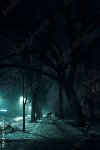 Street in fog with lanterns along road with man crossing the street