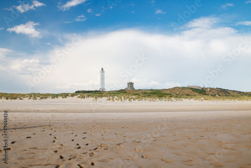 Fototapeta Naklejka Na Ścianę i Meble -  Lighthouse and bunker in the sand dunes on the beach of Blavand, Jutland Denmark Europe