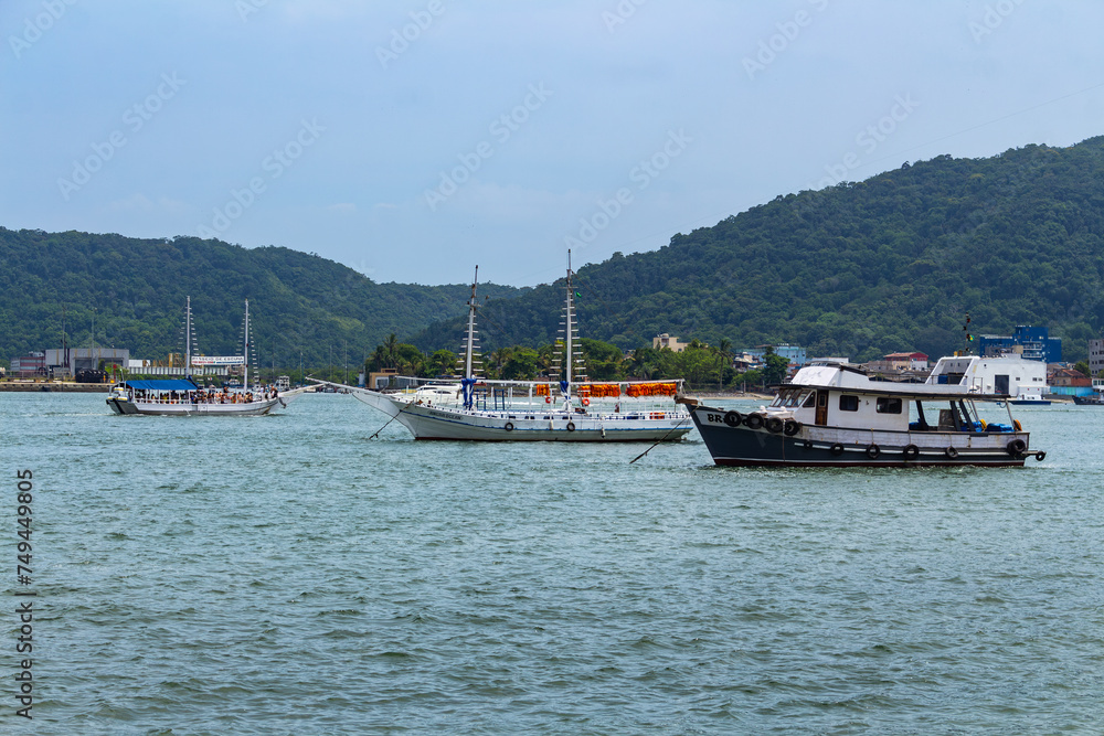 SANTOS, SP, BRAZIL - JANUARY 02, 2024: Schooners and boats in the estuary that gives access to the port, seen from Ponta da Praia. SANTOS, SP, BRAZIL - JANUARY 02, 2024: Schooners and boats in the estuary that gives access to the port, seen from Ponta da Praia.