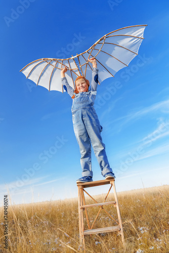 Little boy imagines flying.