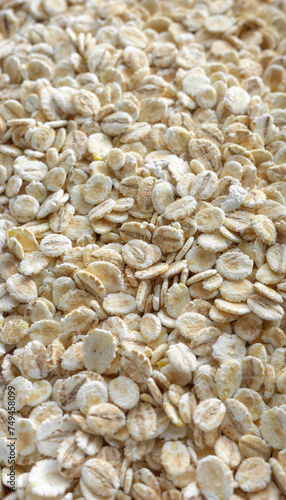 Close up photo of barley flakes, selective focus, food background.