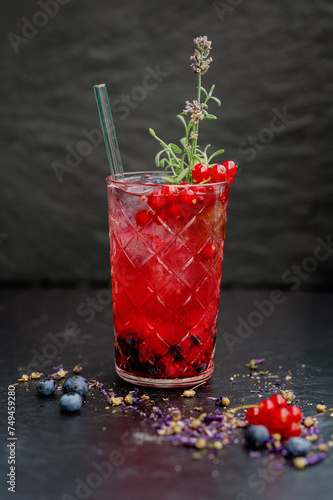 Refreshing wild berry lemonade in transparent glass photo