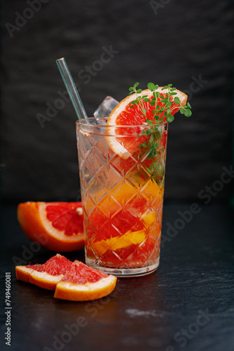 Refreshing grapefruit and orange lemonade in transparent glass photo