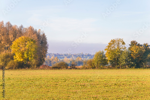 Autumn landscape. Sunny day, view for a hill with a wind turbines