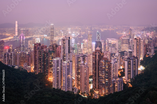 Hong Kong urban skyline with high skyscrapers during moody dusk. .