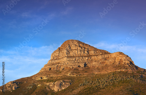 Mountain, peak and natural landscape with blue sky, summer and calm cliff at tranquil travel location. Nature, evening and sustainable environment with earth, sunshine and serene hill in Cape Town