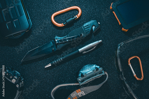 Flat lay of some Outdoor/EDC gear on a dark background. photo