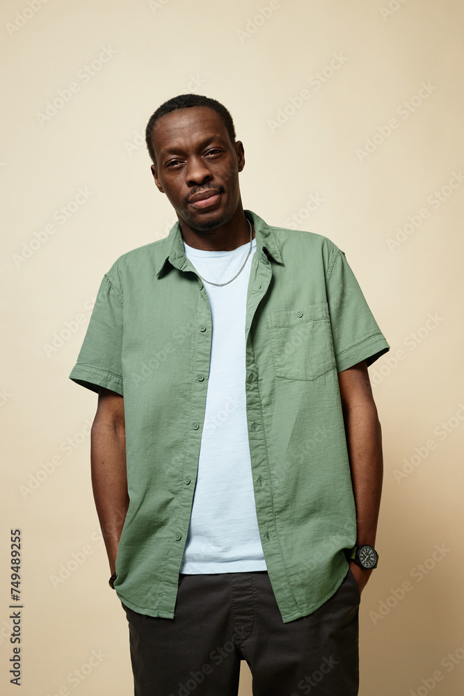 Vertical portrait of skinny Black man wearing casual clothes looking at camera in studio Vertical portrait of skinny Black man wearing casual clothes looking at camera in studio