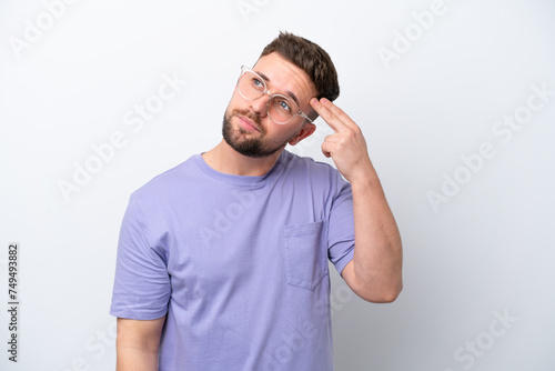 Young caucasian man isolated on white background with problems making suicide gesture
