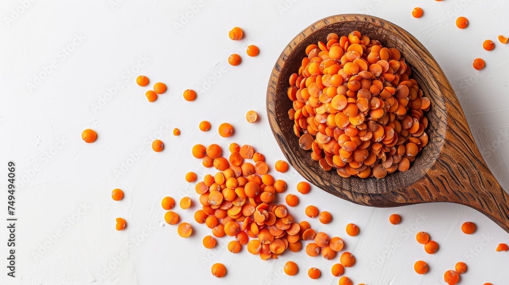 lentils on a wooden spoon on a white background - top view lentils on a wooden spoon on a white background - top view