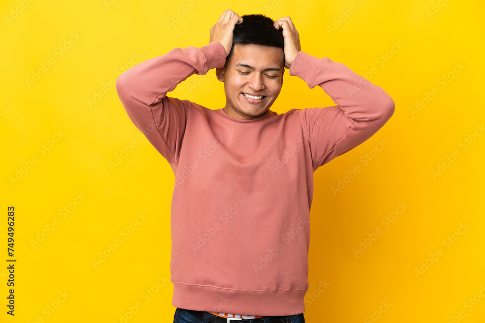 Young Ecuadorian man isolated on yellow background laughing Young Ecuadorian man isolated on yellow background laughing