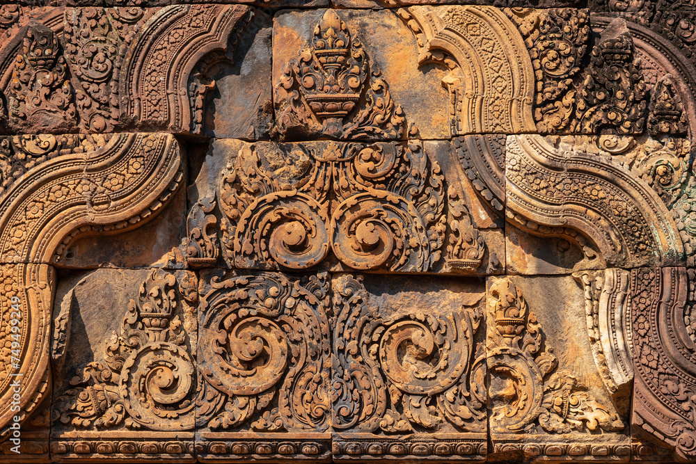 Bas-relief of Banteay Srei, the temple known for its beautiful carvings on red sandstone in Siem Reap, Cambodia.