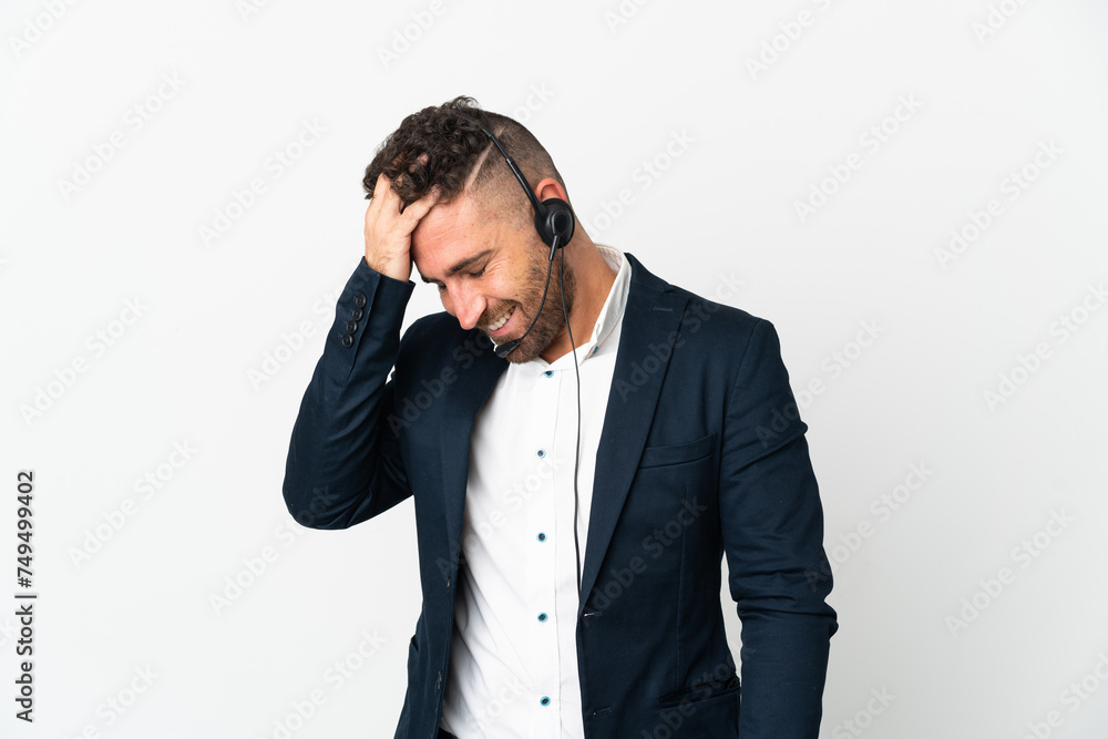 Telemarketer man working with a headset isolated on white background laughing Telemarketer man working with a headset isolated on white background laughing