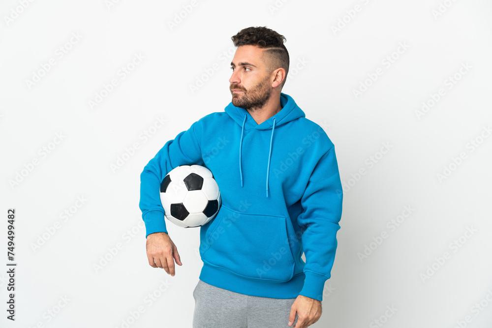 Caucasian man isolated on white background with soccer ball