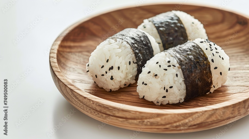 onigri rice balls in a wooden round plate on white background onigri rice balls in a wooden round plate on white background