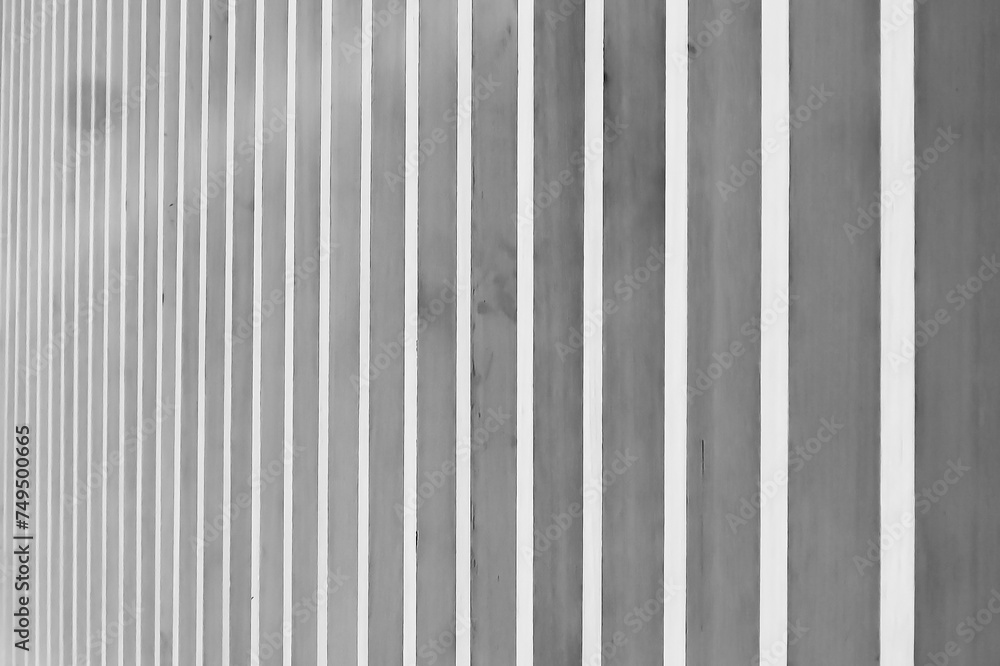 Close up vertical brown wood with black steel battens, abstract texture background, selective focus.