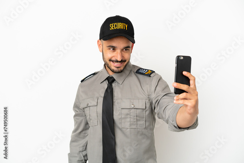 Young security  caucasian man isolated on white background making a selfie