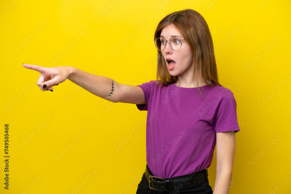 Young English woman isolated on yellow background pointing away Young English woman isolated on yellow background pointing away